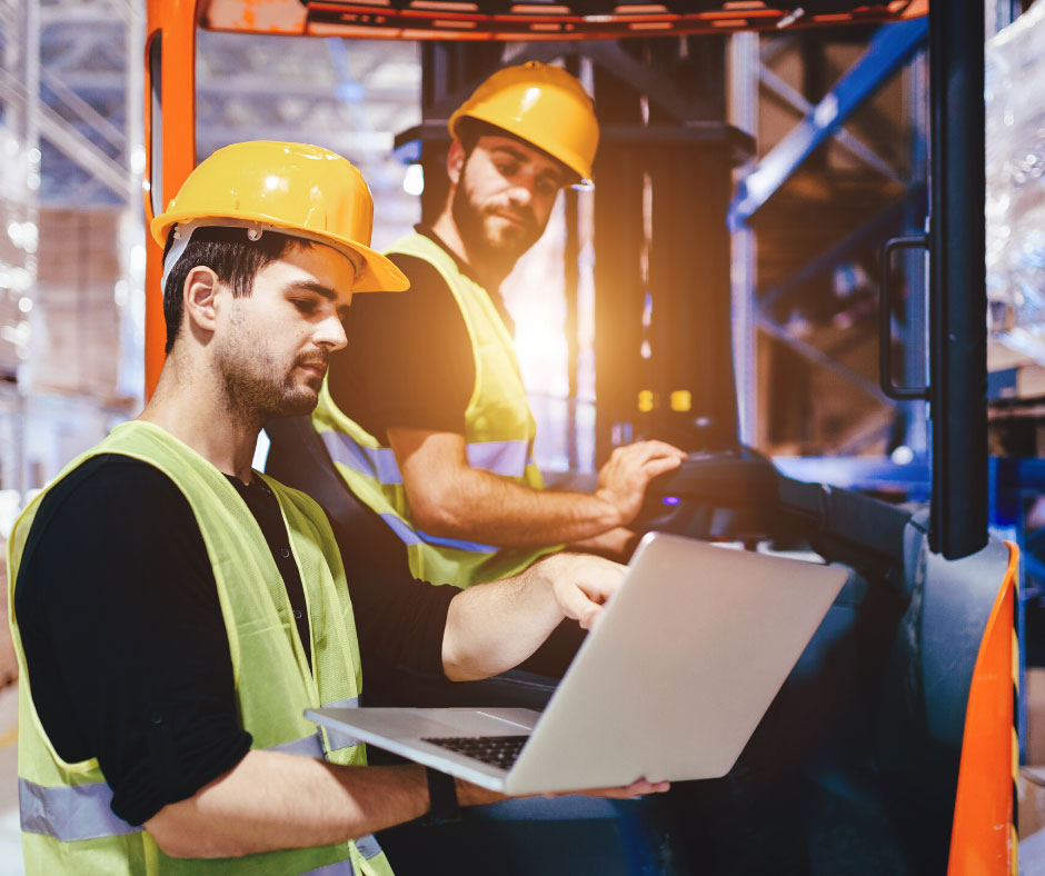 Warehouse workers using distribution management software