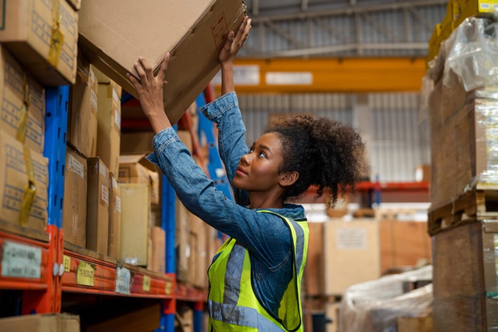 warehouse worker organizes boxes in warehouse