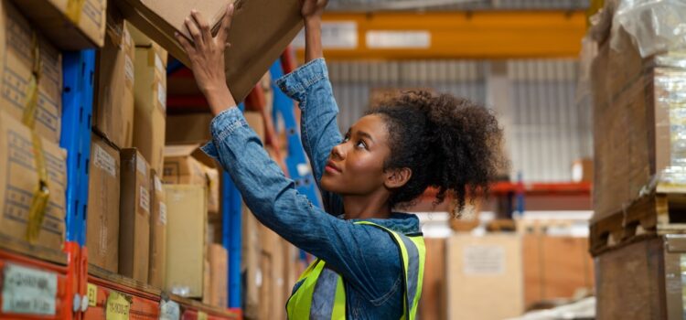 warehouse worker organizes boxes in warehouse