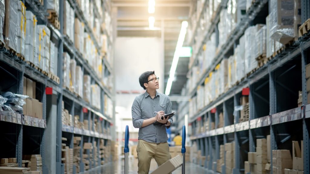 warehouse manager examines inventory