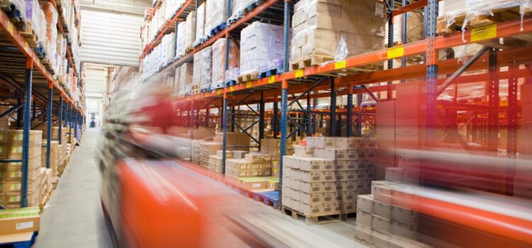 workers moving through a large company warehouse