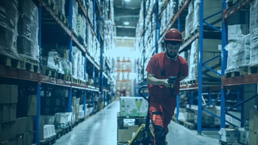 Warehouse worker pulling a pallet jack