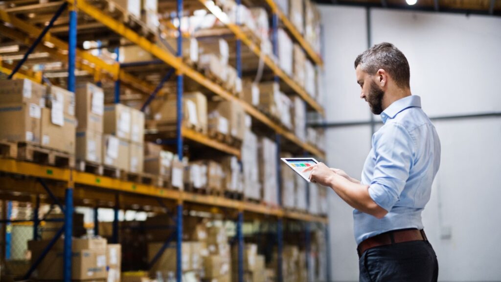 Worker using inventory tracking software