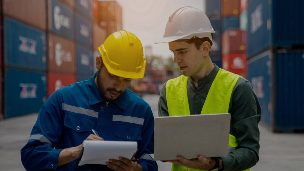 Two warehouse managers reviewing metrics